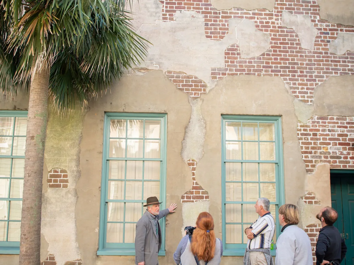 a group of people walking in front of a building