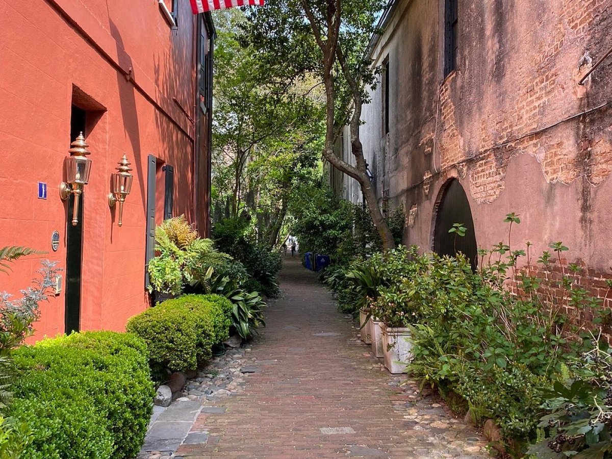 a large brick building with graffiti on the side of a road