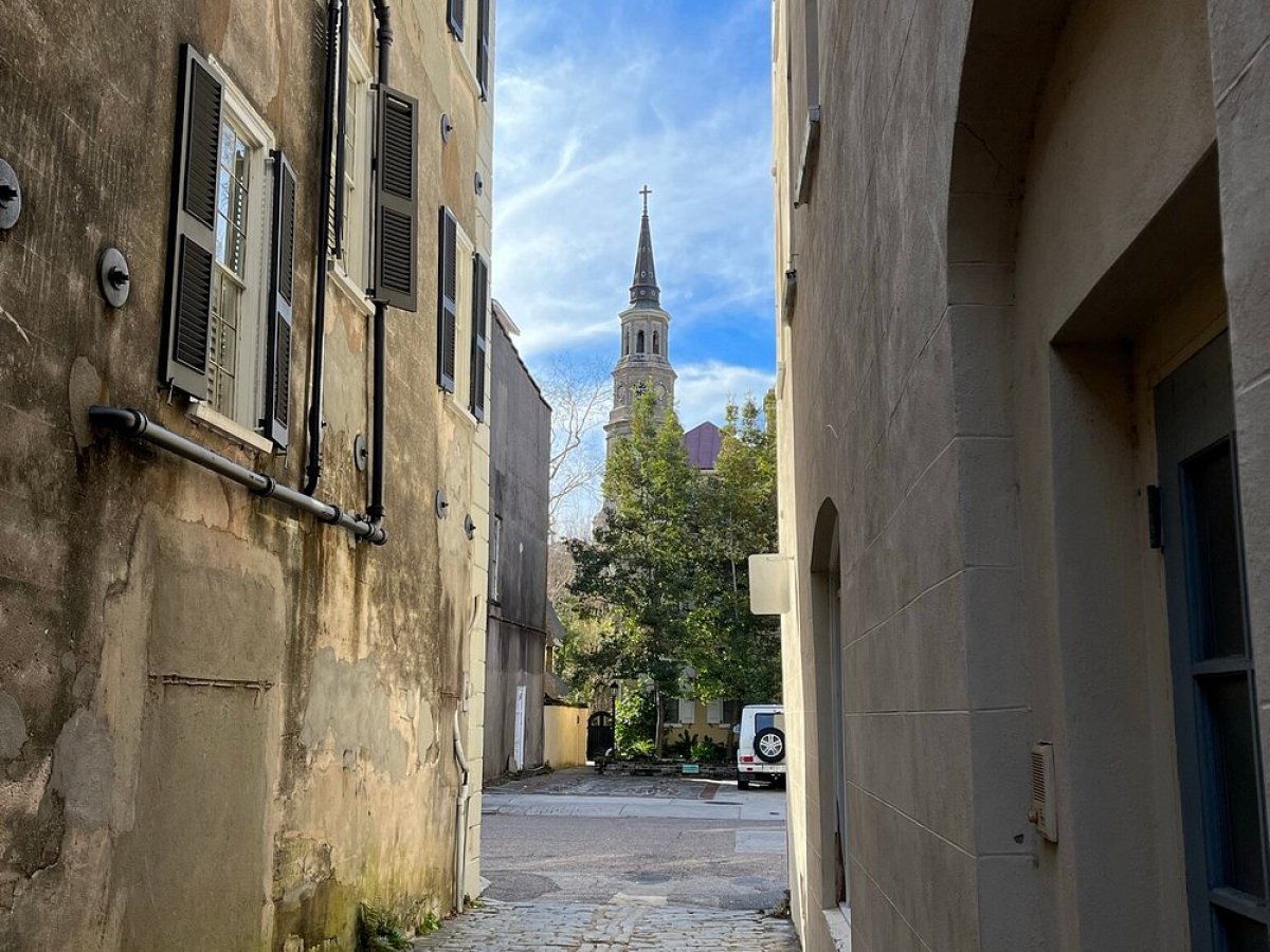 a large brick building with graffiti on the side of the street