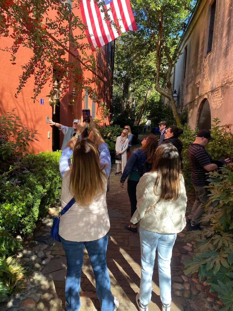 a group of people standing next to a tree