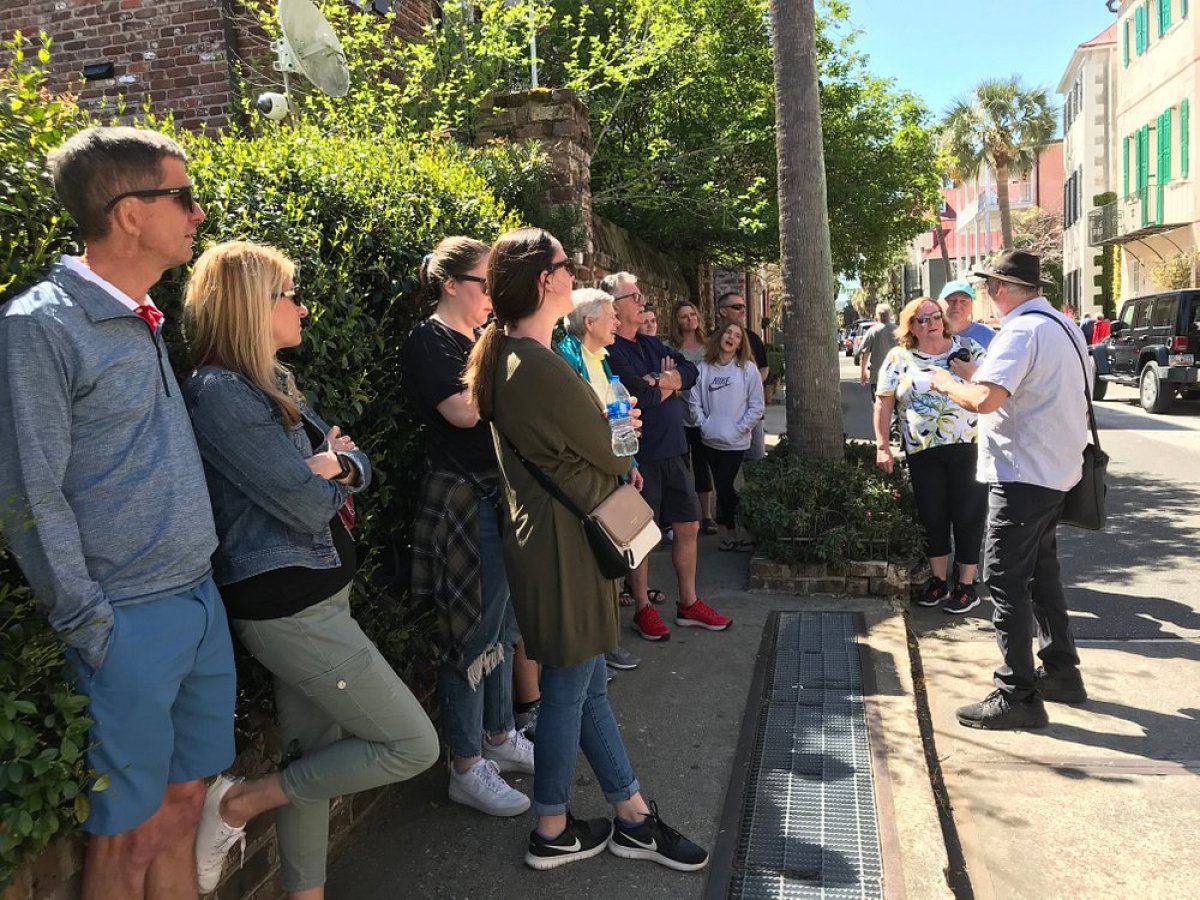 a group of people standing on a sidewalk